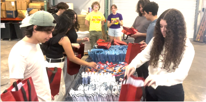 Young volunteers sorting and filling donation bags together